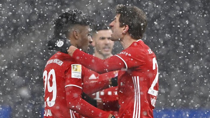 Bayerns Kingsley Coman, left, celebrates after scoring his sides opening goal during the German Bundesliga soccer match between Hertha BSC Berlin and FC Bayern Munich in Berlin, Germany, Friday, Feb. 5, 2021. (John MacDougall/pool via AP)