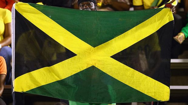 KINGSTON, JAMAICA - JUNE 07: A fan waves a flag before the USA takes on Jamaica in the FIFA 2014 World Cup Qualifier at National Stadium on June 7, 2013 in Kingston, Jamaica. (Photo by Streeter Lecka/Getty Images)