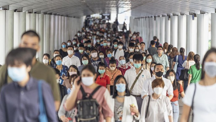 Bangkok, Thailand - Mar 2020 : Crowd of unrecognizable business people wearing surgical mask for prevent coronavirus Outbreak in rush hour working day on March 18, 2020 at Bangkok transportation