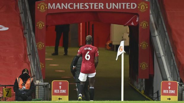 Manchester United's Paul Pogba walks off the pitch into the tunnel after getting injured during an English Premier League soccer match between Manchester United and Everton at the Old Trafford stadium in Manchester, England, Saturday Feb. 6, 2021. (Michael Regan/Pool via AP)