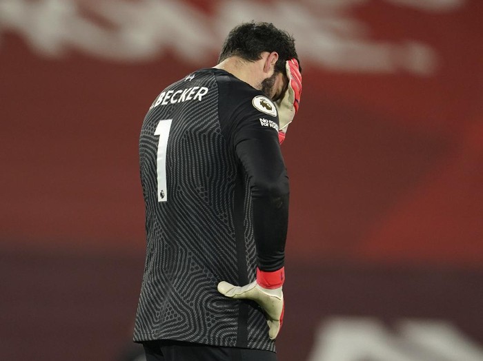 Liverpool's goalkeeper Alisson reacts after Manchester City's Raheem Sterling scored his side's third goal during the English Premier League soccer match between Liverpool and Manchester City at Anfield Stadium, Liverpool, England, Sunday, Feb. 7, 2021. (AP photo/Jon Super, Pool)