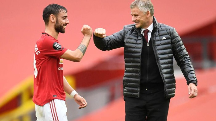 MANCHESTER, ENGLAND - JULY 04: Bruno Fernandes of Manchester United and Ole Gunnar Solskjaer, Manager of Manchester United elbow bump following the Premier League match between Manchester United and AFC Bournemouth  at Old Trafford on July 04, 2020 in Manchester, England. Football Stadiums around Europe remain empty due to the Coronavirus Pandemic as Government social distancing laws prohibit fans inside venues resulting in all fixtures being played behind closed doors. (Photo by Peter Powell/Pool via Getty Images)