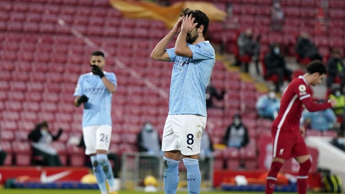 Manchester Citys Ilkay Gundogan reacts after failing to score from the penalty spot during the English Premier League soccer match between Liverpool and Manchester City at Anfield Stadium, Liverpool, England, Sunday, Feb. 7, 2021. (Tim Keeton/Pool via AP)