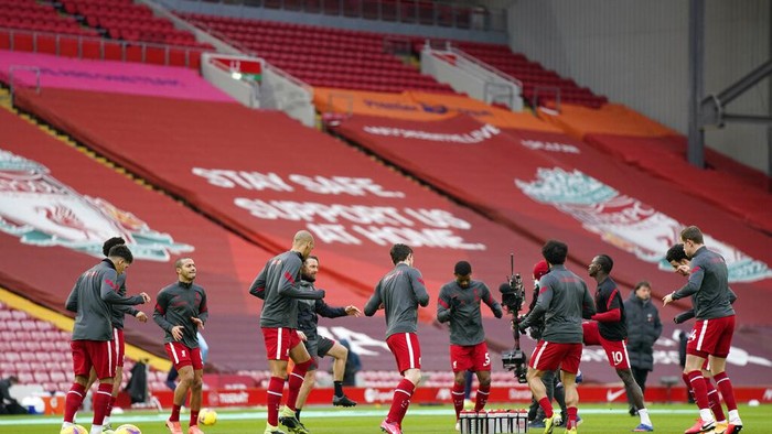 Liverpool players exercise during warmup before the English Premier League soccer match between Liverpool and Manchester City at Anfield Stadium, Liverpool, England, Sunday, Feb. 7, 2021. (Tim Keeton/Pool via AP)