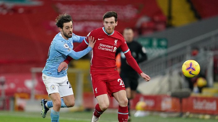 LIVERPOOL, ENGLAND - FEBRUARY 07: Andrew Robertson of Liverpool is challenged by Bernardo Silva of Manchester City during the Premier League match between Liverpool and Manchester City at Anfield on February 07, 2021 in Liverpool, England. Sporting stadiums around the UK remain under strict restrictions due to the Coronavirus Pandemic as Government social distancing laws prohibit fans inside venues resulting in games being played behind closed doors (Photo by Jon Super - Pool/Getty Images)