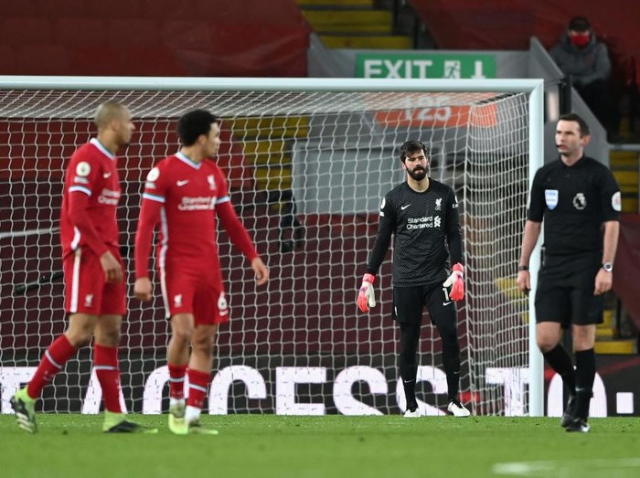LIVERPOOL, ENGLAND - FEBRUARY 07: Alisson Becker of Liverpool looks dejected after Liverpool's third goal scored by Raheem Sterling (Not pictured) of Manchester City during the Premier League match between Liverpool and Manchester City at Anfield on February 07, 2021 in Liverpool, England. Sporting stadiums around the UK remain under strict restrictions due to the Coronavirus Pandemic as Government social distancing laws prohibit fans inside venues resulting in games being played behind closed doors. (Photo by Laurence Griffiths/Getty Images)
