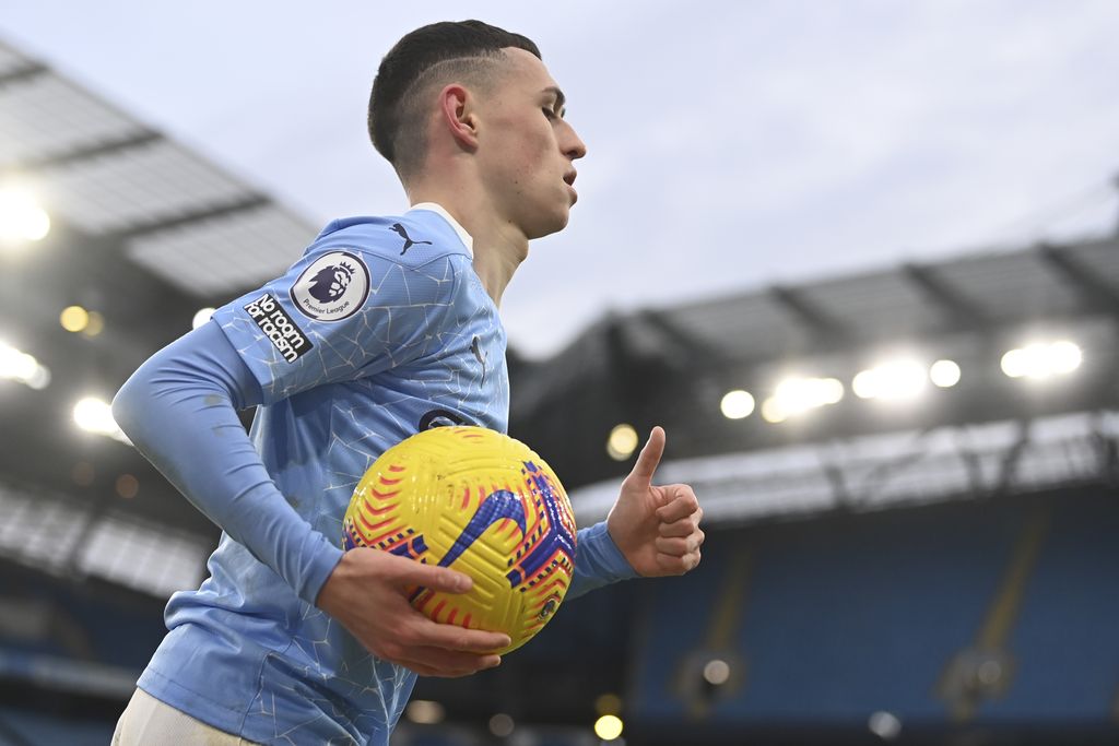 Manchester City's Phil Foden carries the ball during the English Premier League match between Manchester City and Sheffield United at the the City of Manchester Stadium in Manchester, England, Saturday, Jan. 30, 2021. (Laurence Griffiths/Pool via AP)