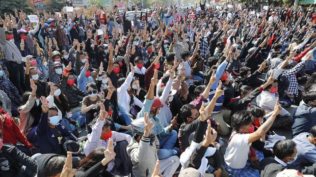 Protesters flash the three-fingered salute, a symbol of resistance, during a protest in Mandalay, Myanmar, Tuesday, Feb. 9, 2021. Protesters continued to gather Tuesday morning in major cities breaching Myanmar's new military rulers ban of public gathering of five or more issued on Monday intended to crack down on peaceful public protests opposing their takeover. (AP Photo)