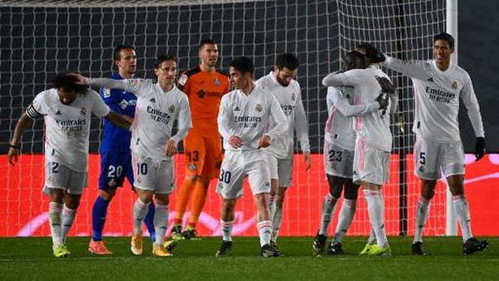 Real Madrids French defender Ferland Mendy (3R) celebrates with teammates next to Getafes Spanish goalkeeper David Soria after scoring during the Spanish league football match between Real Madrid CF and Getafe CF at the Alfredo di Stefano stadium in Valdebebas, on the outskirts of Madrid on February 9, 2021. (Photo by GABRIEL BOUYS / AFP)