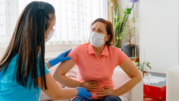 Abdominal pain patient woman having medical exam with doctor on illness from stomach cancer, irritable bowel syndrome, pelvic discomfort, Indigestion, Diarrhea, GERD (gastro-esophageal reflux disease)