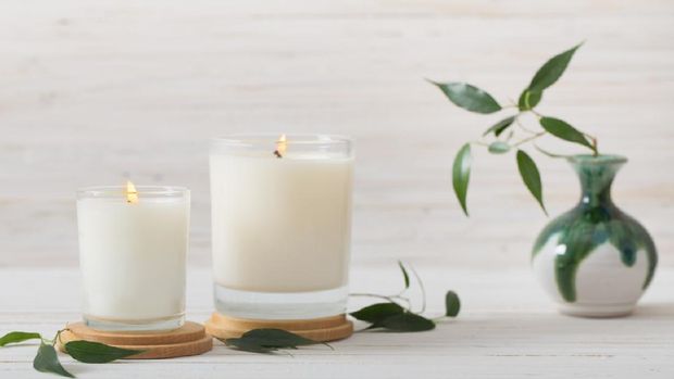 scented candles on white background