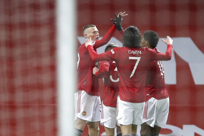 Manchester Uniteds Scott McTominay celebrates after scoring his sides first goal during the English FA Cup 5th round soccer match between Manchester United and West Ham United at Old Trafford in Manchester, England, Tuesday, Feb. 9, 2021. (Martin Rickett/Pool via AP)