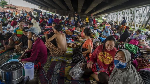 Korban banjir berteduh di bawah Jembatan layang sebagai tempat pengungsian sementara, Pamanukan, Kabupaten Subang, Jawa Barat, Selasa (9/2/2021). Berdasarkan data yang terhimpun, sebanyak 32 ribu orang dari 5.764 kepala keluarga mengungsi akibat terdampak banjir yang melanda 75 desa dari 11 kecamatan di Kabupaten Subang. ANTARA FOTO/Novrian Arbi/rwa.