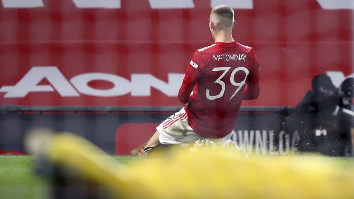 Manchester Uniteds Scott McTominay celebrates after scoring his sides first goal during the English FA Cup 5th round soccer match between Manchester United and West Ham United at Old Trafford in Manchester, England, Tuesday, Feb. 9, 2021. (Martin Rickett/Pool via AP)