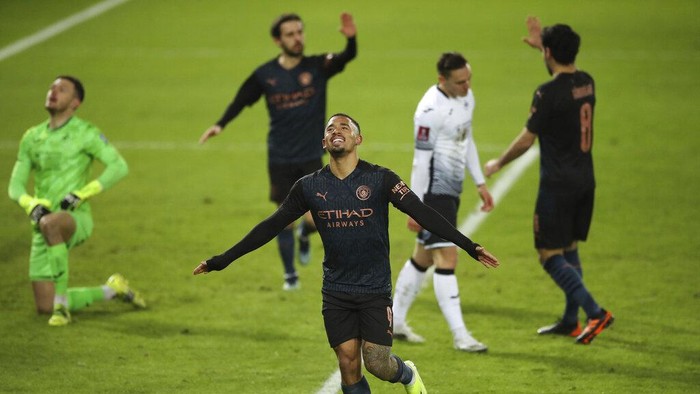 Manchester Citys Gabriel Jesus celebrates scoring against Swansea City during the English FA Cup fifth round soccer match at Liberty Stadium, Swansea, Wales, Wednesday Feb. 10, 2021. (Nick Potts/PA via AP)