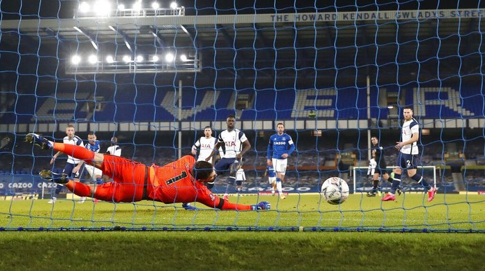 Tottenhams goalkeeper Hugo Lloris fails to save the ball as Evertons Richarlison scores his sides second goal during the English FA Cup 5th round soccer match between Everton and Tottenham Hotspur at Goodison Park, Liverpool, England, Wednesday, Feb. 10, 2021. (Martin Rickett/Pool via AP)