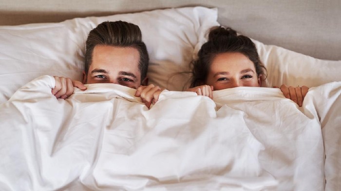 Ilustrasi Posisi Seks Shot of an affectionate young couple spending some quality time together in their bedroom at home