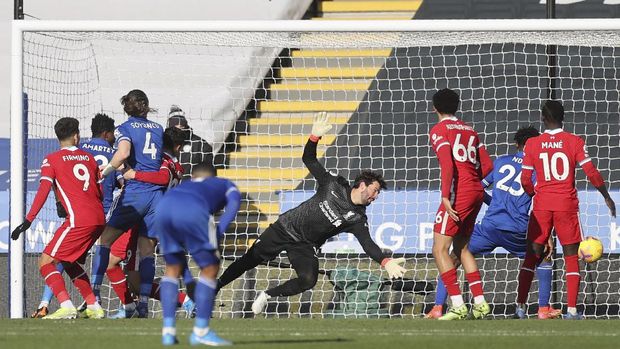 Leicester City vs Liverpool Liverpool's goalkeeper Alisson, center, fails to save the ball as Leicester's James Maddison scores his side's opening goal during the English Premier League soccer match between Leicester City and Liverpool at the King Power Stadium in Leicester, England, Saturday, Feb. 13, 2021. (Carl Recine/Pool Photo via AP)
