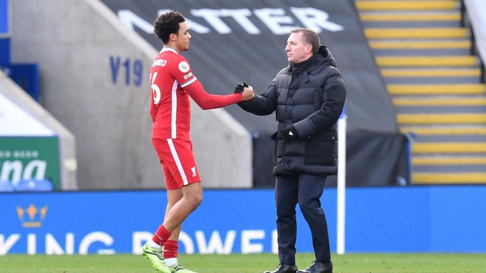 LEICESTER, ENGLAND - FEBRUARY 13: Brendan Rodgers, Manager of Leicester City interacts with Trent Alexander-Arnold of Liverpool following the Premier League match between Leicester City and Liverpool at The King Power Stadium on February 13, 2021 in Leicester, England. Sporting stadiums around the UK remain under strict restrictions due to the Coronavirus Pandemic as Government social distancing laws prohibit fans inside venues resulting in games being played behind closed doors. (Photo by Paul Ellis - Pool/Getty Images)