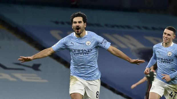 Manchester City's Ilkay Gundogan celebrates after scoring his side's third goal during the English Premier League soccer match between Manchester City and Tottenham Hotspur at Etihad Stadium, Manchester, England, Saturday, Feb. 13, 2021. (AP photo/Rui Vieira, Pool)