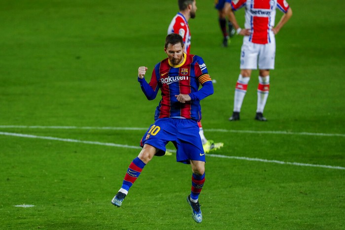 Barcelonas Lionel Messi celebrates after scoring his sides second goal during the Spanish La Liga soccer match between FC Barcelona and Alaves at the Camp Nou stadium in Barcelona, Spain, Saturday, Feb. 13, 2021. (AP Photo/Joan Monfort)