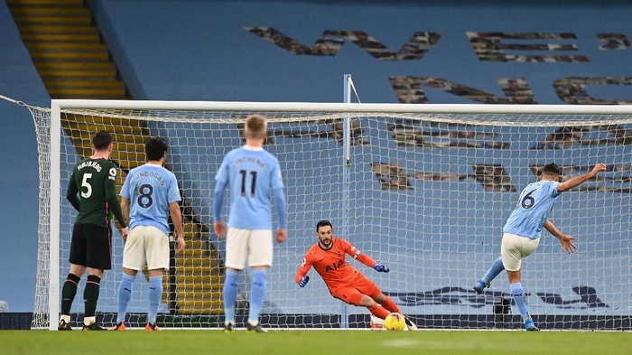 MANCHESTER, ENGLAND - FEBRUARY 13: Rodrigo of Manchester City scores their sides first goal from the penalty spot past Hugo Lloris of Tottenham Hotspur during the Premier League match between Manchester City and Tottenham Hotspur at Etihad Stadium on February 13, 2021 in Manchester, England. Sporting stadiums around the UK remain under strict restrictions due to the Coronavirus Pandemic as Government social distancing laws prohibit fans inside venues resulting in games being played behind closed doors. (Photo by Shaun Botterill/Getty Images)