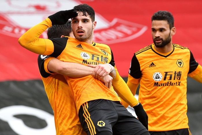 SOUTHAMPTON, ENGLAND - FEBRUARY 14: Pedro Neto of Wolverhampton Wanderers celebrates after scoring their teams second goal with teammate Ruben Neves during the Premier League match between Southampton and Wolverhampton Wanderers at St Marys Stadium on February 14, 2021 in Southampton, England. Sporting stadiums around the UK remain under strict restrictions due to the Coronavirus Pandemic as Government social distancing laws prohibit fans inside venues resulting in games being played behind closed doors. (Photo by Andy Rain - Pool/Getty Images)