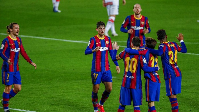 Barcelonas Lionel Messi celebrates after scoring his sides second goal during the Spanish La Liga soccer match between FC Barcelona and Alaves at the Camp Nou stadium in Barcelona, Spain, Saturday, Feb. 13, 2021. (AP Photo/Joan Monfort)