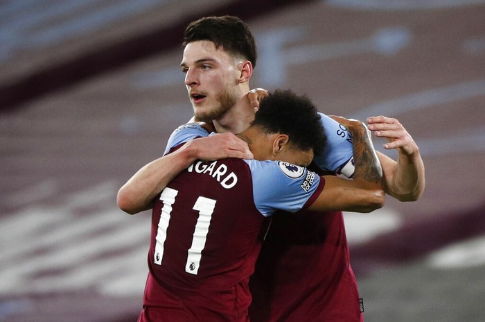 West Hams Declan Rice, rear, celebrates with Jesse Lindgard after scoring the opening goal during an English Premier League soccer match between West Ham and Sheffield United at the London stadium in London, England, Monday Feb. 15, 2021. (John Sibley/Pool via AP)