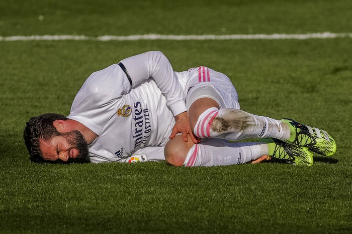 Real Madrids Nacho grimaces in pain during the Spanish La Liga soccer match between Real Madrid and Valencia at the Alfredo Di Stefano stadium in Madrid, Spain, Sunday, Feb. 14, 2021. (AP Photo/Manu Fernandez)