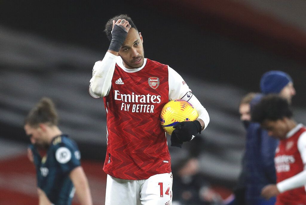 Arsenal's Pierre-Emerick Aubameyang walks off with the match ball after the English Premier League soccer match between Arsenal and Leeds United at the Emirates stadium in London, England, Sunday, Feb. 14, 2021. (Adam Davy/Pool via AP)