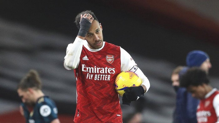 Arsenals Pierre-Emerick Aubameyang walks off with the match ball after the English Premier League soccer match between Arsenal and Leeds United at the Emirates stadium in London, England, Sunday, Feb. 14, 2021. (Adam Davy/Pool via AP)