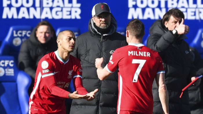 Liverpools James Milner, right, is substituted by Liverpools Thiago during the English Premier League soccer match between Leicester City and Liverpool at the King Power Stadium in Leicester, England, Saturday, Feb. 13, 2021. (Michael Regan/Pool Photo via AP)