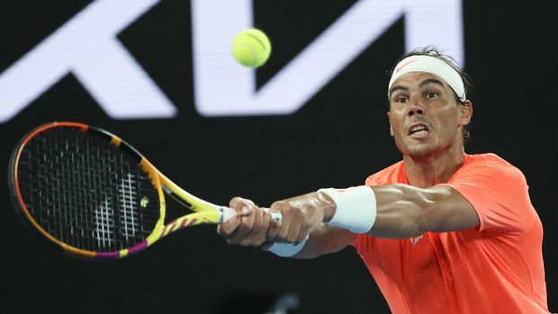 Spain's Rafael Nadal hits a backhand return to Greece's Stefanos Tsitsipas during their quarterfinal match at the Australian Open tennis championship in Melbourne, Australia, Wednesday, Feb. 17, 2021.(AP Photo/Hamish Blair)