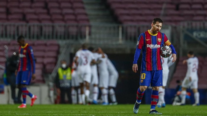 Barcelonas Lionel Messi reacts after PSGs Kylian Mbappe scored his sides first goal during the Champions League round of 16, first leg soccer match between FC Barcelona and Paris Saint-Germain at the Camp Nou stadium in Barcelona, Spain, Tuesday, Feb. 16, 2021. (AP Photo/Joan Monfort)