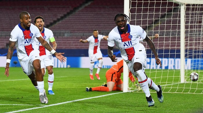 BARCELONA, SPAIN - FEBRUARY 16: Moise Kean of Paris Saint-Germain celebrates after scoring their sides third goal during the UEFA Champions League Round of 16 match between FC Barcelona and Paris Saint-Germain at Camp Nou on February 16, 2021 in Barcelona, Spain. Sporting stadiums around Spain remain under strict restrictions due to the Coronavirus Pandemic as Government social distancing laws prohibit fans inside venues resulting in games being played behind closed doors. (Photo by David Ramos/Getty Images)