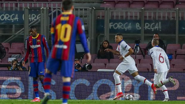 PSG's Kylian Mbappe celebrates after scoring his side's first goal during the Champions League round of 16, first leg soccer match between FC Barcelona and Paris Saint-Germain at the Camp Nou stadium in Barcelona, Spain, Tuesday, Feb. 16, 2021. (AP Photo/Joan Monfort)