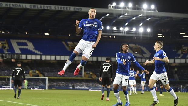 Everton's Richarlison leaps as he celebrates scoring his side's first goal during the English Premier League soccer match between Everton and Manchester City at Goodison Park stadium, in Liverpool, England, Wednesday, Feb. 17, 2021. (Peter Powell/Pool via AP)