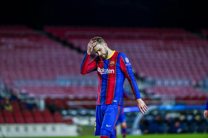 Barcelonas Gerard Pique reacts during the Champions League round of 16, first leg soccer match between FC Barcelona and Paris Saint-Germain at the Camp Nou stadium in Barcelona, Spain, Tuesday, Feb. 16, 2021. (AP Photo/Joan Monfort)