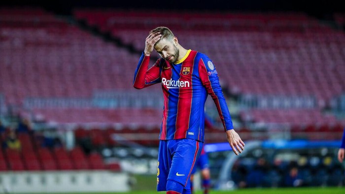 Barcelonas Gerard Pique reacts during the Champions League round of 16, first leg soccer match between FC Barcelona and Paris Saint-Germain at the Camp Nou stadium in Barcelona, Spain, Tuesday, Feb. 16, 2021. (AP Photo/Joan Monfort)