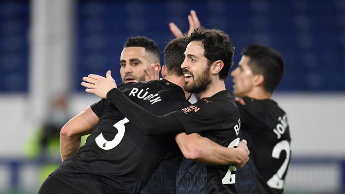 LIVERPOOL, ENGLAND - FEBRUARY 17: Bernardo Silva of Manchester City celebrates with team mate Ruben Dias (L) after scoring their sides third goal during the Premier League match between Everton and Manchester City at Goodison Park on February 17, 2021 in Liverpool, England. Sporting stadiums around the UK remain under strict restrictions due to the Coronavirus Pandemic as Government social distancing laws prohibit fans inside venues resulting in games being played behind closed doors. (Photo by Peter Powell - Pool/Getty Images)