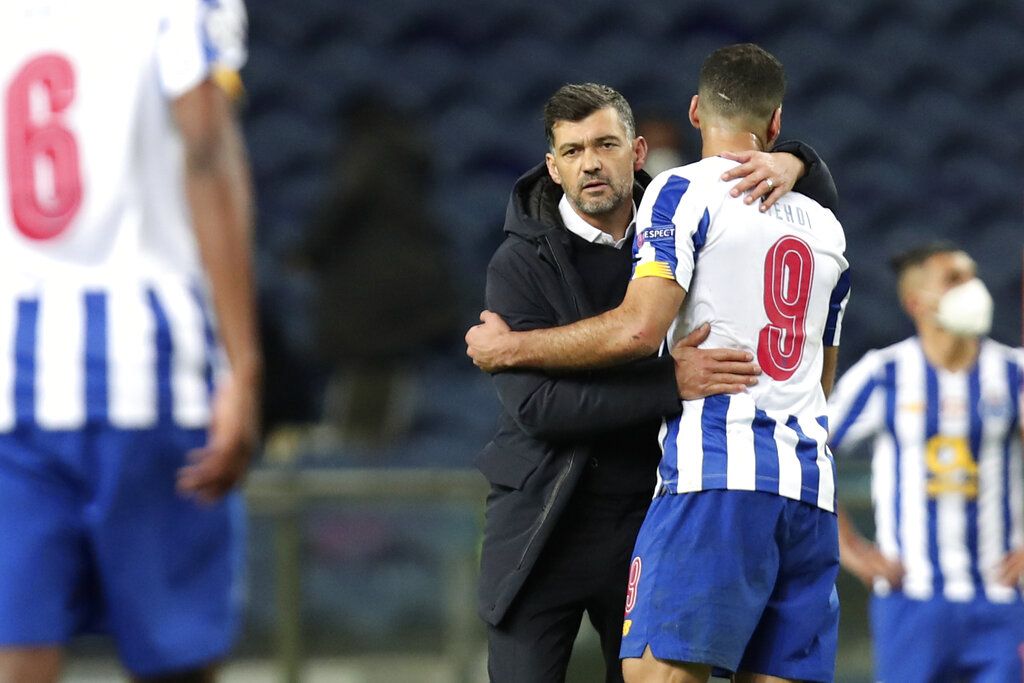 Porto's Moussa Marega, center, celebrates with Mehdi Taremi, center left, after scoring his side's second goal during the Champions League round of 16, first leg, soccer match between FC Porto and Juventus at the Dragao stadium in Porto, Portugal, Wednesday, Feb. 17, 2021. (AP Photo/Luis Vieira)
