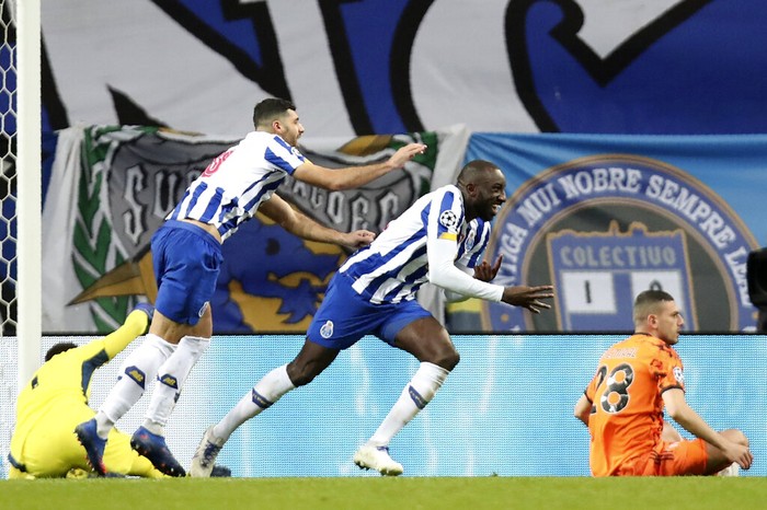 Portos Moussa Marega, center, celebrates with Mehdi Taremi, center left, after scoring his sides second goal during the Champions League round of 16, first leg, soccer match between FC Porto and Juventus at the Dragao stadium in Porto, Portugal, Wednesday, Feb. 17, 2021. (AP Photo/Luis Vieira)
