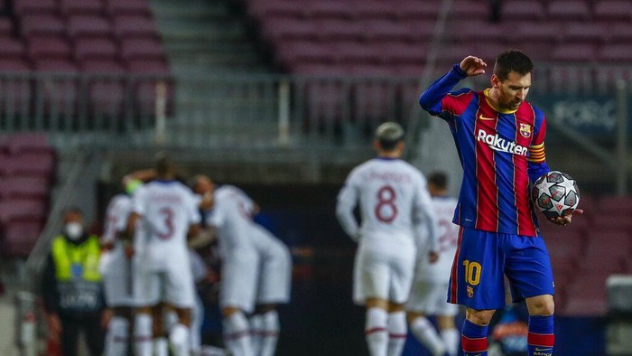 Barcelonas Lionel Messi reacts after PSGs Kylian Mbappe scored his sides first goal during the Champions League round of 16, first leg soccer match between FC Barcelona and Paris Saint-Germain at the Camp Nou stadium in Barcelona, Spain, Tuesday, Feb. 16, 2021. (AP Photo/Joan Monfort)