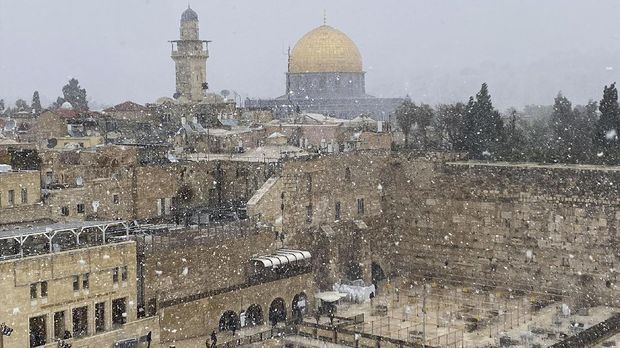 Masjid Al Aqsa Diselimuti Salju A general view of Jerusalem's Old City shows the Western Wall, Judaism's holiest prayer site, in the foreground and the Dome of the Rock, located on the compound known to Muslims as Noble Sanctuary and to Jews as Temple Mount, in the background, as the snow starts to fall in Jerusalem February 17, 2021 REUTERS/Ilan Rosenberg