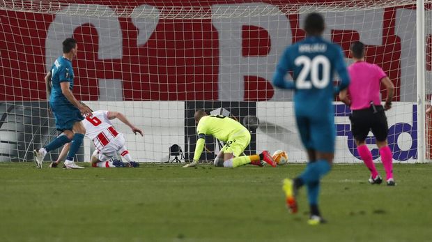 Red Star's Radovan Pankov, second left, scores an own goal past his goalkeeper during the Europa League round of 32 first leg soccer match between Red Star and AC Milan at the Rajko Mitic Stadium in Belgrade, Serbia, Thursday, Feb. 18, 2021. (AP Photo/Darko Vojinovic)