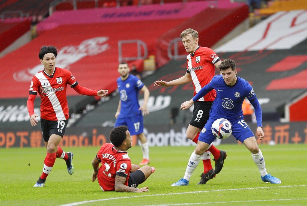Chelsea's Mason Mount, right, vies with Southampton's Japanese midfielder Takumi Minamino, left, Southampton's Ryan Bertrand, second right, and Southampton's James Ward-Prowse during the English Premier League soccer match between Chelsea and Southampton at St. Mary's Stadium in Southampton, England, Saturday, Feb.20, 2021. (Kirsty Wigglesworth/Pool via AP)