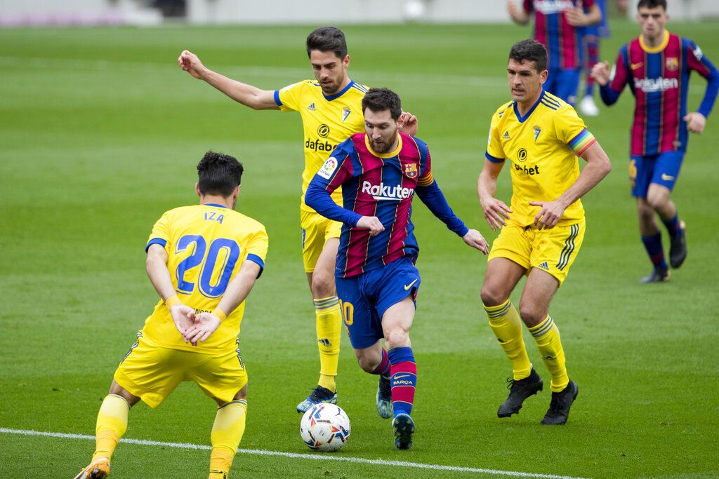 Barcelona's Lionel Messi scores from a penalty kick, during the Spanish La Liga soccer match between FC Barcelona and Cadiz at the Camp Nou stadium in Barcelona, Spain, Sunday, Feb. 21, 2021. (AP Photo/Joan Monfort)