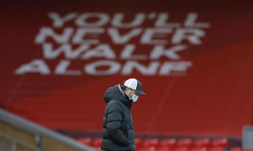 Liverpool's manager Jurgen Klopp walks on the pitch ahead of the English Premier League soccer match between Liverpool and Everton at Anfield in Liverpool, England, Saturday, Feb. 20, 2021. (Phil Noble/ Pool via AP)