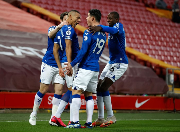 LIVERPOOL, ENGLAND - FEBRUARY 20: Richarlison of Everton celebrates with teammates Seamus Coleman, James Rodriguez and Abdoulaye Doucoure after scoring his teams first goal during the Premier League match between Liverpool and Everton at Anfield on February 20, 2021 in Liverpool, England. Sporting stadiums around the UK remain under strict restrictions due to the Coronavirus Pandemic as Government social distancing laws prohibit fans inside venues resulting in games being played behind closed doors. (Photo by Phil Noble - Pool/Getty Images)